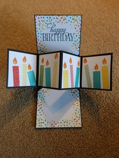 three birthday cards with candles on them sitting on the floor in front of a brown carpet