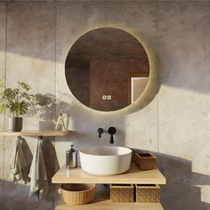 a bathroom with a round mirror above the sink and wooden shelves on the wall next to it