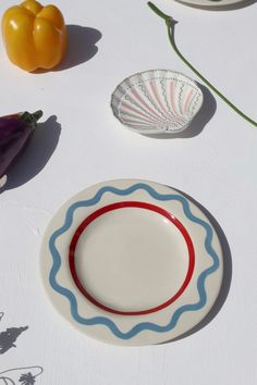 an empty plate sitting on top of a table next to other plates and bowls filled with vegetables