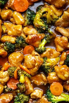 chicken, broccoli and carrots are in a sauce