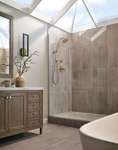 a bath room with a sink a mirror and a bath tub sitting next to a window