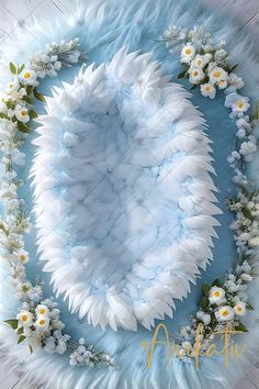 a blue and white background with flowers on it's side, surrounded by feathers