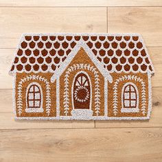 a door mat with a gingerbread house on it