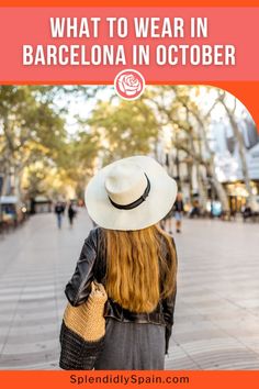 a woman with long hair wearing a white hat and black dress is walking down the street