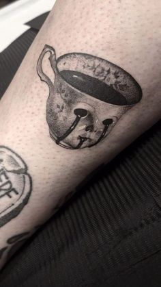 a black and white photo of a person's leg with a tattoo on it