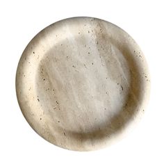 a white plate with speckles on it is shown in the middle of the image