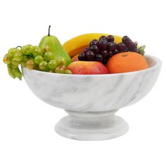 a marble bowl filled with assorted fruit