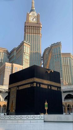 the kabab in front of some tall buildings with a clock on it's side