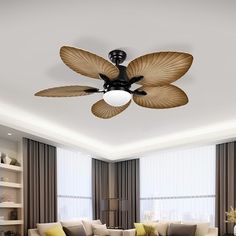 a living room filled with furniture and a ceiling fan in the middle of the room