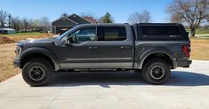 a large gray truck parked on top of a driveway