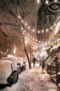 an instagram page with snow covered streets and people walking down the street at night