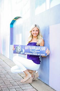 a woman holding up a sign that says rifframbah zoo