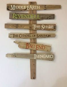 a cross made out of wooden planks with different sayings