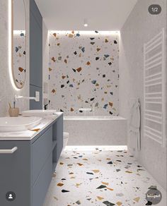 the bathroom is decorated in white and grey with colorful confetti on the walls