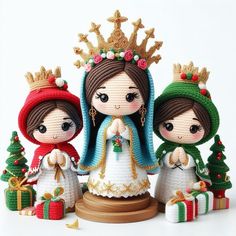 three little figurines are dressed up in christmas outfits and holding presents, one is wearing a tiara