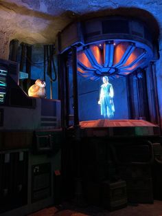 a man standing on top of a stage in front of a tv screen at night