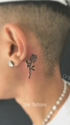 a man with a rose tattoo on his ear