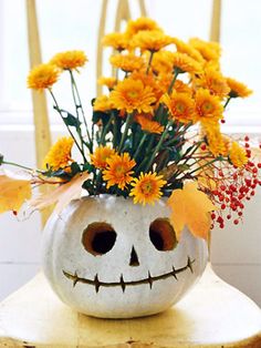 a vase filled with yellow flowers sitting on top of a table