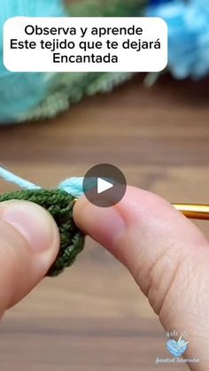 someone crocheting the end of a piece of green yarn with a knitting needle