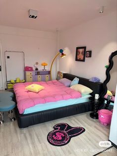 a bedroom with mickey mouse bed and other items