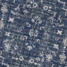 an area rug with blue and white designs on it