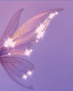 a butterfly flying through the air with its wings spread out and glowing stars on it's back