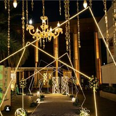 an entrance to a building decorated with lights and chandeliers