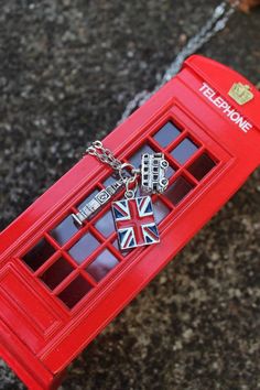 a red phone booth with british symbols on it