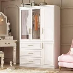 a white armoire sitting next to a pink chair