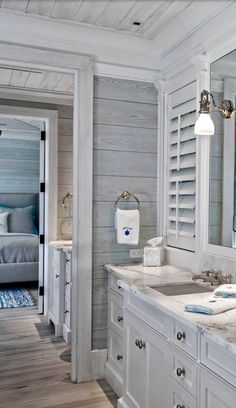 a white bathroom with two sinks and mirrors