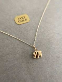 14K Solid Gold Tiny Mini Elephant Necklace - 14K Solid Gold ★ Quantity: One  ★ Color : Yellow Gold  ★ Materials : 14K Solid Gold ★ Elephant Size : 9mm ★ Chain Length : 16 inches ★ Suitable for delicate and sensitive skin. ★ Comes elegantly packaged in our black velvet signature box, ready for gifting or keeping! Afro Jewelry, Elephant Necklace Gold, Palm Necklace, Elephant Jewelry, Gold Elephant, Pretty Jewelry Necklaces, Gold Jewelry Stores, Fancy Jewellery Designs, Butterfly Earrings Stud