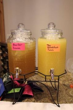 two jars with labels on them sitting on a counter