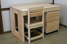 a wooden desk with two drawers on the bottom and one drawer open in front of it