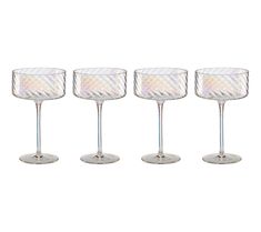 four wine glasses sitting next to each other