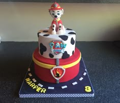 a birthday cake made to look like a fireman on top of a cowgirl