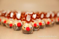 a group of plastic reindeer ornaments sitting on top of a wooden table