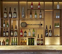 an assortment of liquor bottles on shelves in a bar