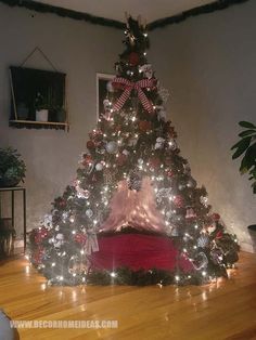 a decorated christmas tree with lights in a living room