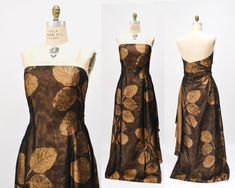 two mannequins dressed in brown and gold dresses with floral designs on them