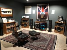 a living room filled with furniture and sound equipment