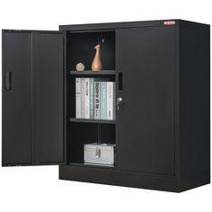 a black cabinet with two doors and some books on it's shelf next to a vase