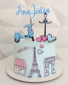 a birthday cake decorated with the eiffel tower