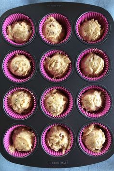 a muffin tin filled with cupcakes on top of a blue tablecloth