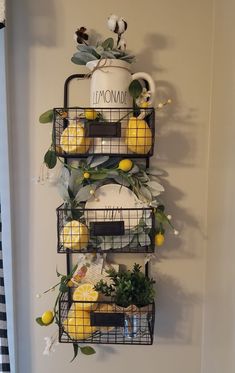 three tiered metal rack holding lemons and other items on the wall in a bathroom