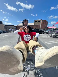 a man sitting in the back of a pickup truck with his feet up and another person standing behind him