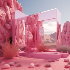 there is a pink structure in the desert with rocks and plants around it, surrounded by mountains