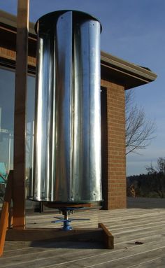 a large metal object sitting on top of a wooden deck