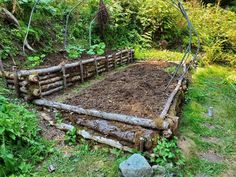 a garden bed made out of logs and dirt