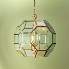 a chandelier hanging from the ceiling with two lights on each side and one light in the middle