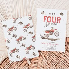 two folded cards sitting on top of a wicker basket next to a woven basket